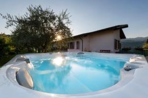 a large swimming pool in a backyard with a house at Villa Margherita Portese in San Felice del Benaco