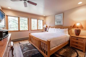a bedroom with a bed and a flat screen tv at Townsend Place by Vail Realty in Beaver Creek
