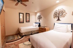 a bedroom with two beds and a ceiling fan at Townsend Place by Vail Realty in Beaver Creek