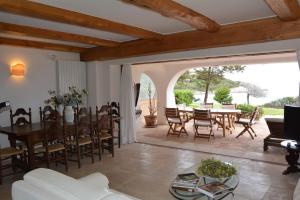- salon na otwartym planie ze stołem i krzesłami w obiekcie Sea & Beach Apartments Porto Cervo Costa Smeralda w mieście Porto Cervo