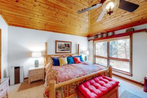 a bedroom with a bed and a wooden ceiling at Appaloosa Retreat in Pagosa Springs