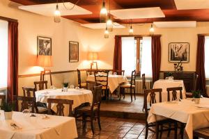 a restaurant with tables and chairs with white tablecloths at Borgovecchio Albergo in Balerna