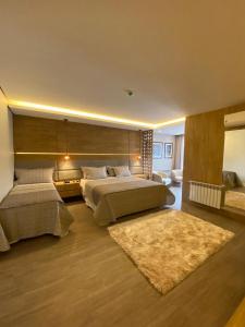 a large bedroom with two beds and a rug at Pousada Brombatti in Nova Petrópolis +23 photos