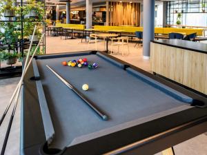 a pool table in a room with a pool ball at ibis Hotel Muenchen City West in Munich