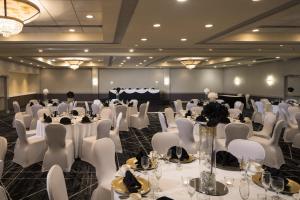 a banquet hall with white tables and white chairs at Holiday Inn Washington-College Pk I-95 in College Park +49 photos