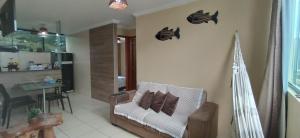 a living room with a white couch and a table at Maragogi Flat Residence in Maragogi