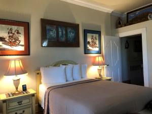 a bedroom with a large bed and two lamps on tables at El Amador Downtown Luxury Inn in Tucson