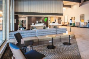 a lobby with a couch and tables and chairs at Holiday Inn Richland on the River, an IHG Hotel in Richland