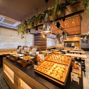 a bakery with a bunch of pastries on a counter at Super Hotel Tokyo Akabane Eki Minamiguchi in Tokyo