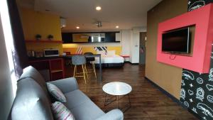 a living room with a couch and a room with a bed at Sense Hotel Taiping in Taiping