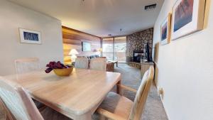 a dining room with a wooden table and chairs at Bridges #105 Condo in Mammoth Lakes