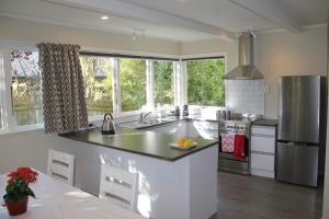 a kitchen with a sink and a refrigerator at Linton Cottage in Palmerston North