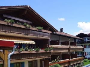 an apartment building with potted plants on the balconies at Sehnsucht-Allgaeu in Oberstaufen