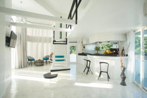 a living room with a staircase and a kitchen at Royal PALAZZO Italian Apartments in Boracay