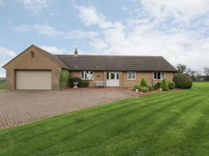 a house with a large lawn in front of it at Holly Edge in Saltburn-by-the-Sea