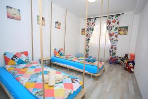 a bedroom with two beds and a swing at Happy Family in Braşov
