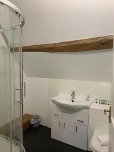 a bathroom with a sink and a shower at The Maidens Chambers in Canterbury