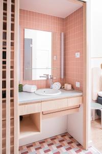 
a bathroom with a tub, sink and mirror at Hotel Helka in Helsinki
