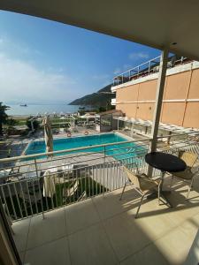 a balcony with a view of a swimming pool at Cosmos Hotel in Vasiliki