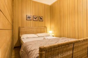 a bedroom with a bed and two pictures on the wall at Appartamento Volpi in Mezzana