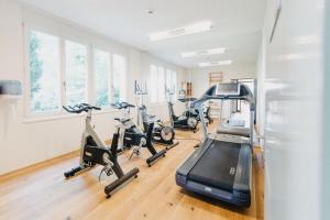 a gym with several treadmills and exercise bikes at Gasthof Sunnebad in Sternenberg