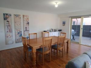 a kitchen and dining room with a wooden table and chairs at Parkway Place B&B in Clifton Springs