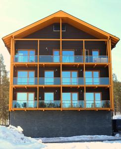 a large building with glass windows on it at Tunturinlaita D6 in Levi