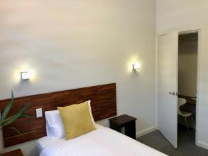 a hotel room with a bed and two lamps at Gallery Hotel in Fremantle