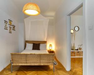 a small bedroom with a bed and a lamp at State Opera Alley Lodge in Vienna