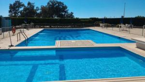 a large swimming pool with blue water at Zibibbo Beach Apartments - Trapani in Trapani