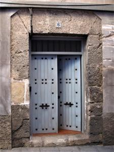 a set of doors in a stone building at La Casita de Nerea XL in Cuenca