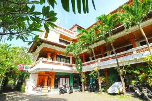 a building with motorcycles parked in front of it at Bali Senia Hotel in Sanur