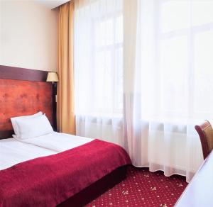 Postel nebo postele na pokoji v ubytování Rixwell Old Riga Palace Hotel