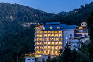 a hotel in the mountains at night at Fortune Park, Dalhousie - Member ITC's Hotel Group in Dalhousie
