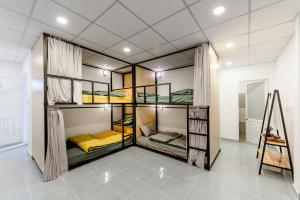 a room with four bunk beds in it at Homestay Vườn Pháp II in Buon Ma Thuot