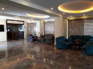 a lobby with couches and chairs in a building at Mert Seaside Hotel in Marmaris