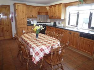a kitchen with a table with flowers on it at Boherbue Holiday Home in Boherboy