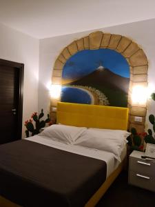 a bedroom with a large bed and a large mirror at Etna Suite Group in Catania