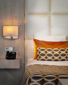 a bedroom with a bed and a tv on the wall at Van der Valk Hotel Oostzaan - Amsterdam in Oostzaan