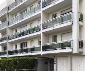 a white building with balconies on the side of it at PETIT STUDIO SYMPA EN CENTRE VILLE in Le Touquet-Paris-Plage