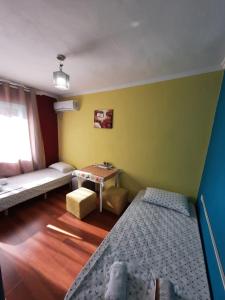 a small room with two beds and a table at My Apartments Polican in Poliçan