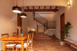 a dining room with a table and a staircase at Casa Rural Cal Joli in Barcelona