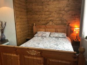 a bedroom with a bed in a room with wooden walls at The Wheatsheaf in Salisbury