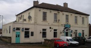 an old white building with cars parked in front of it at Midlands Hotel in Mansfield