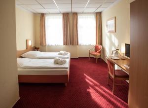 Postel nebo postele na pokoji v ubytování Johanniterhotel