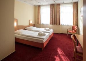 Postel nebo postele na pokoji v ubytování Johanniterhotel + 37 fotografií