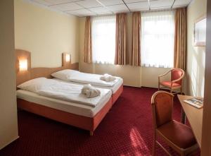Postel nebo postele na pokoji v ubytování Johanniterhotel