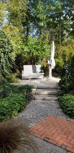 a bench and a statue in a garden at Ferienwohnung Müller in Stendal