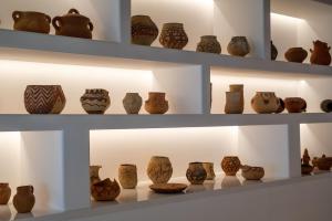 a display of pottery on shelves in a museum at Hotel Fariones in Puerto del Carmen