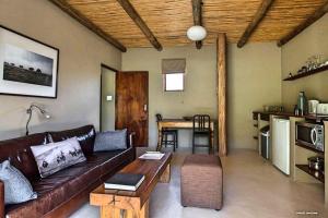 
a living room filled with furniture and a fireplace at River View Cottages in Calitzdorp
